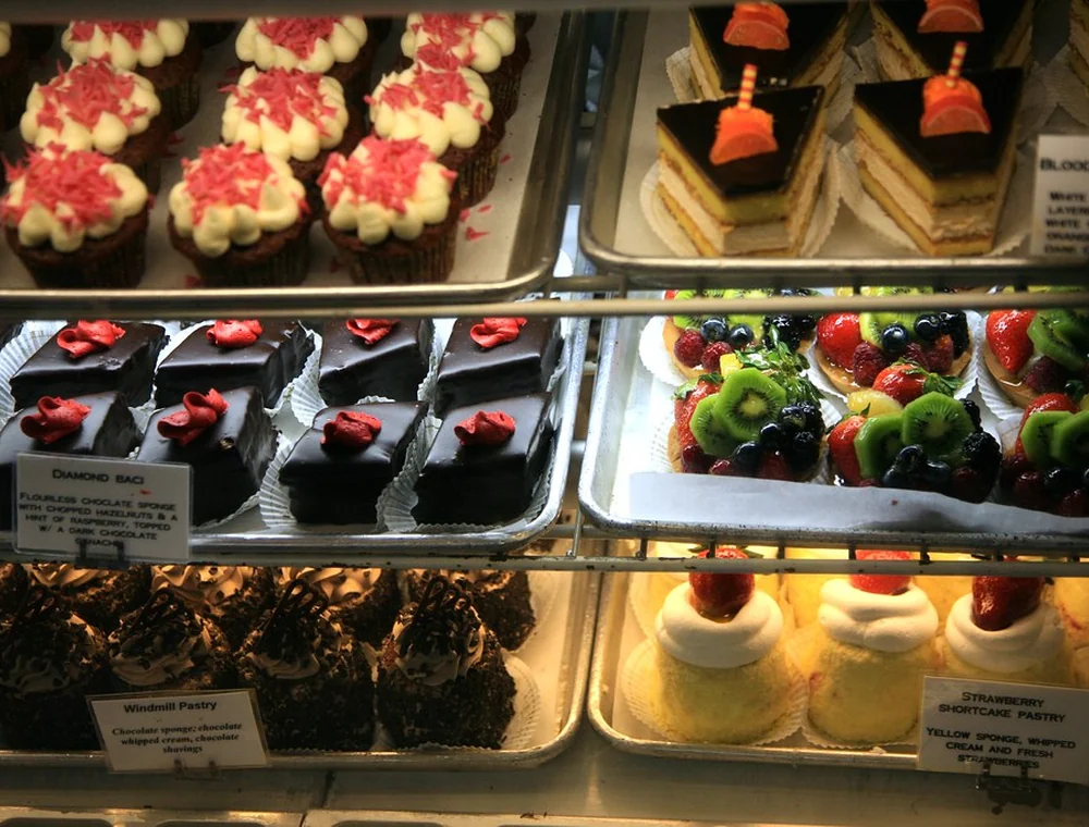 Bakery case filled with pastries and small desserts