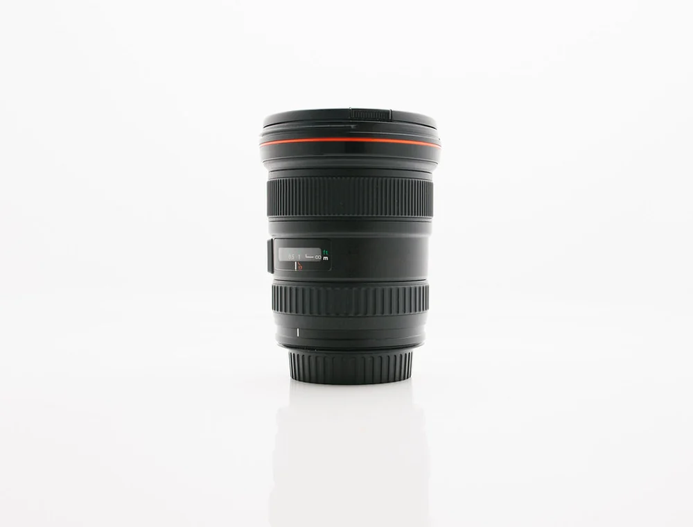 Camera lens standing on a white studio surface