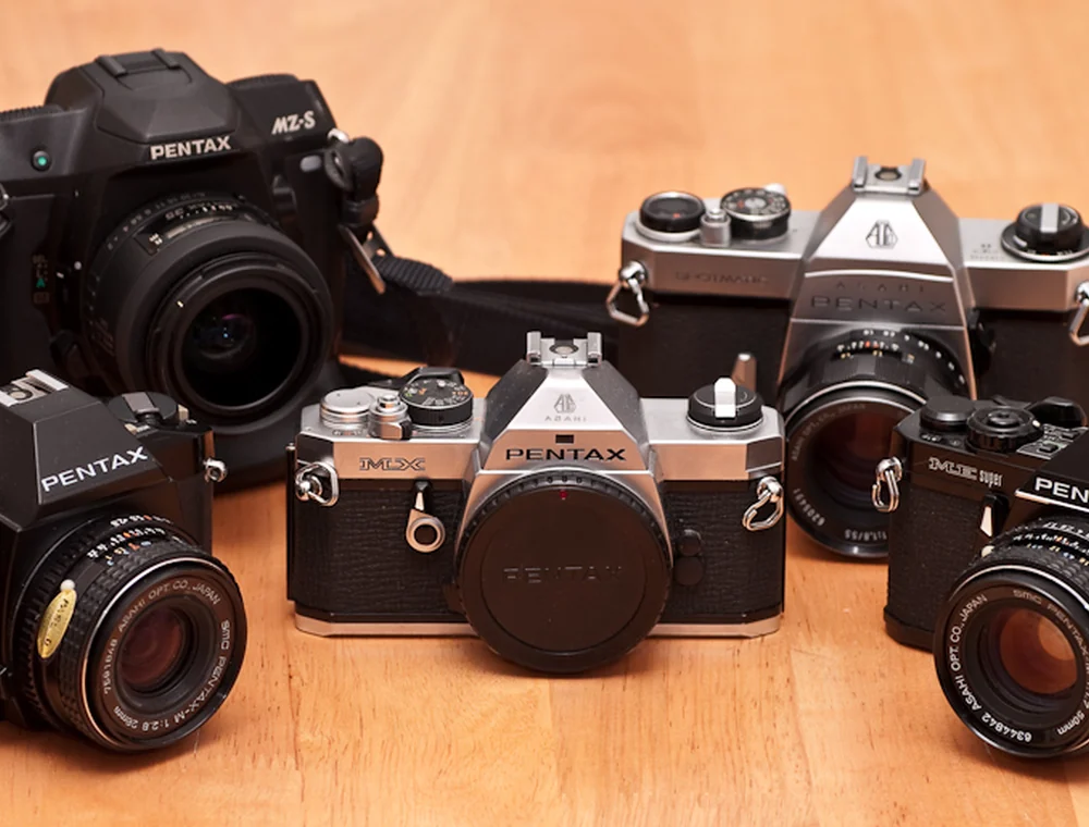 Several film cameras arranged on a tabletop