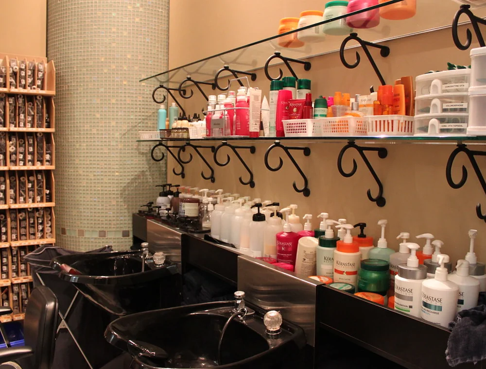 Salon interior with product shelves and wash stations