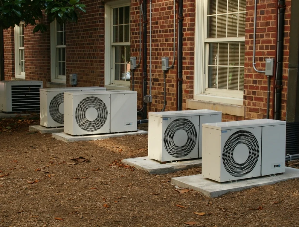 Outdoor air conditioning units beside a brick building