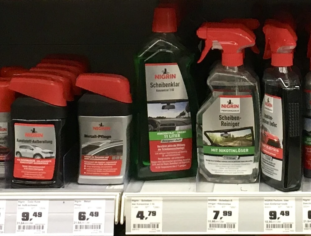 Car cleaning products lined up on a retail shelf