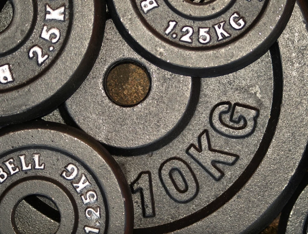 Close-up of weight plates stacked on the floor